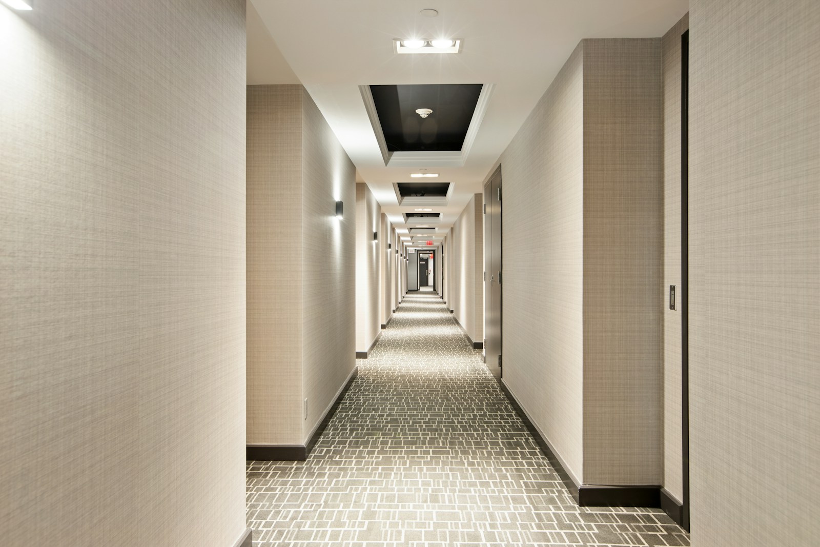 Hotel corridor with coordinated wall finishes, lighting and flooring