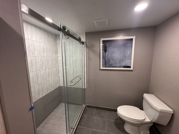 Bathroom with a glass shower enclosure and tiled walls